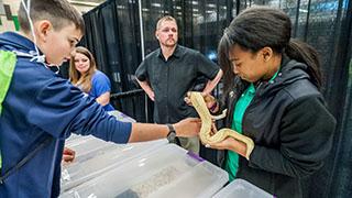 一个学生在斯坦康向孩子们展示一条蛇